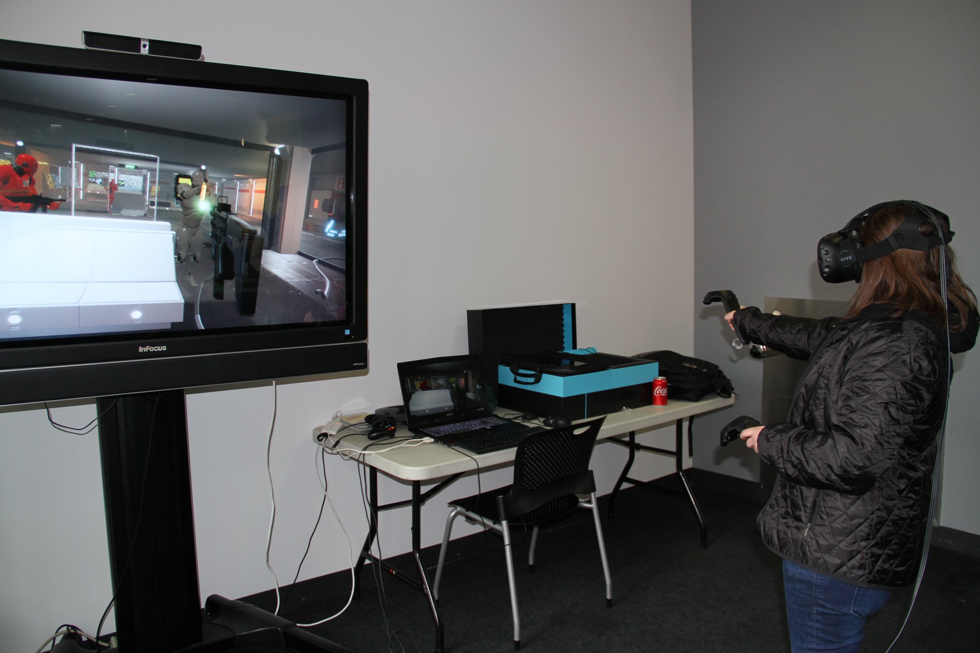 Photograph of a guest playing a VR game built by students (at Manifest).