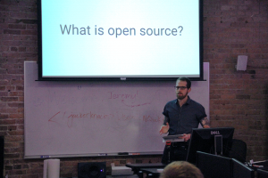 Photograph of IAM Alumni Jeremy Kahn speaking to student programming club HackerJacks