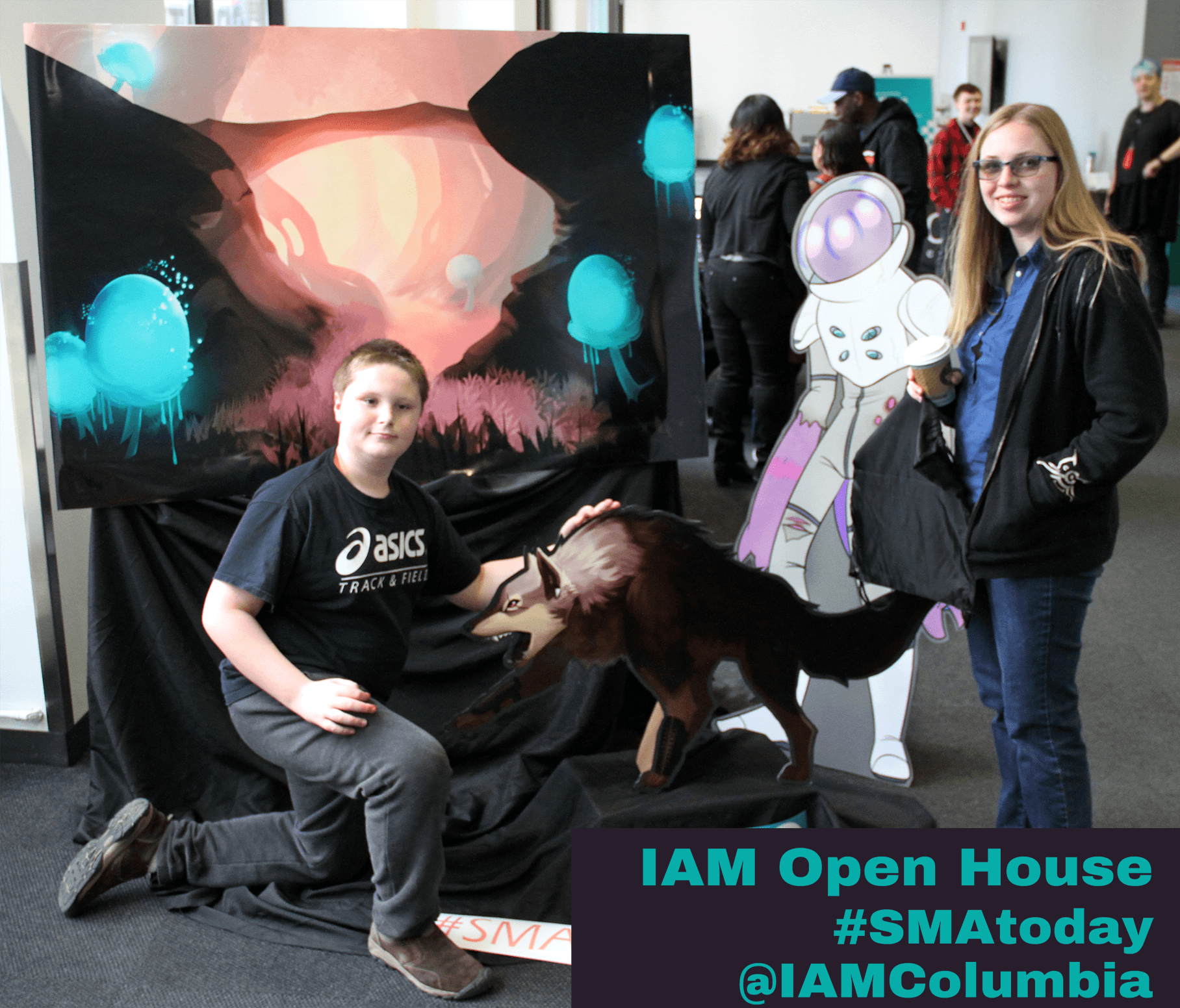 Guests at IAM's open house event 2018 photographed in front of student work