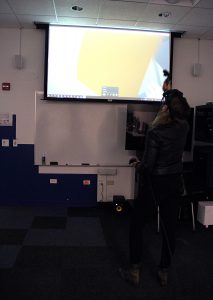Guest playing a VR game at IAM's open house