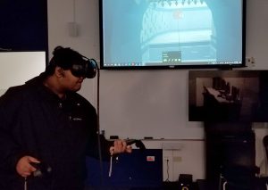 Student playing a VR game developed by IAM students